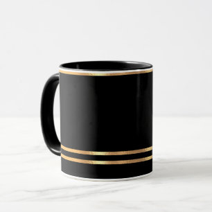 Schwarze und goldene Tasse