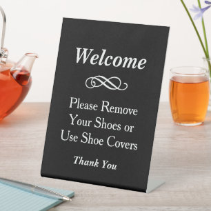 Schwarze Willkommens-Schuhentferner-Abdeckungen Sockelschild