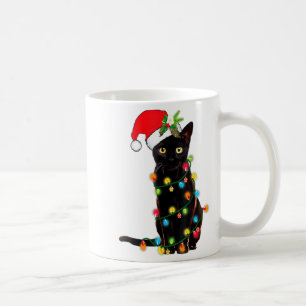 Schwarzer Katzen-Weihnachtsmann, verheddert in Wei Kaffeetasse