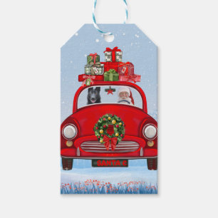 Schwarzer Schäferhund in Auto mit dem Weihnachtsma Geschenkanhänger