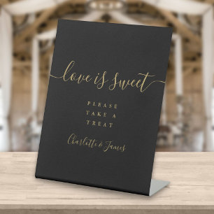 Schwarzes und goldenes elegantes Skript Love Is Sw Sockelschild