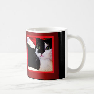 Schwarzweiss-Liebe-Katze auf roter Tasse