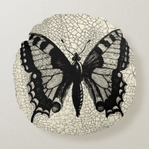 Schwarzweiss-Schmetterling auf gebrochenem Rundes Kissen