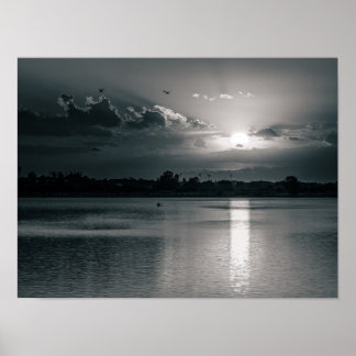 Schwarzweiß-Sonnenuntergang über einem ruhigen See Poster