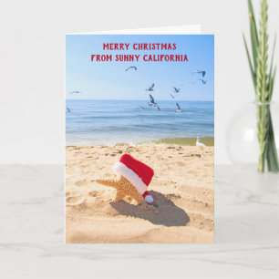 Seestern des Weihnachtsmanns im Sand Feiertagskarte
