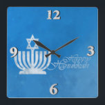 Segnungen der Menorah Quadratische Wanduhr<br><div class="desc">10.75" x 10.75" Acrylclock with an image of a pale blue and white menorah topped with a Star of David on grungy blue See the entire Hanukkah Clock collection under the HOME category in the HOLIDAYS sektion.</div>