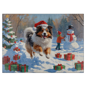 Shetland Sheepdog läuft Schnee mit Weihnachtshut Schneidebrett