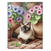 Siamesische Katze und Petunienblumen