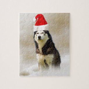 Siberischer Husky-Hund mit Weihnachtsmannmütze im  Puzzle