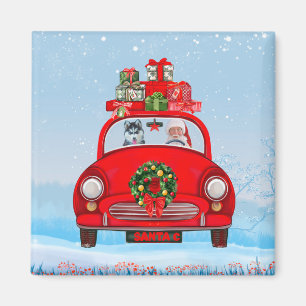 Sibirischer Husky-Hund in Auto mit dem Weihnachtsm Magnet