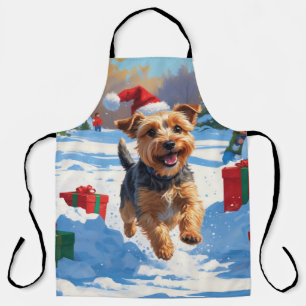 Skye Terrier läuft im Schnee mit Weihnachtshut Schürze
