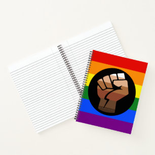 SlipperyJoes Regenbogenflagge mit erhobener Faust Notizbuch