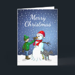 Snowman Gebäude Feiertagskarte<br><div class="desc">Der Junge hat einen Schneemann gebaut,  auf dem sein Hund steht und uriniert,  während der Junge dem Schneemann eine Karottennaase gibt.</div>