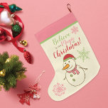 Snowman glaubt an Magie Großer Weihnachtsstrumpf<br><div class="desc">Ein niedlicher Weihnachtsweihnachtssang,  der vom Kaminfeuer eines Schneemanns mit Weihnachtsmannmütze und Karottennase in Rosa,  Rot und Grün mit der Phrase - Glaube an die Magie der Weihnachtszeit!</div>