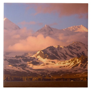 Sonnenaufgang über den Gebirgsketten im Süden Fliese