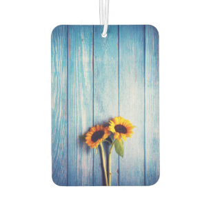 Sonnenblume an der blauen Holzwand Autolufterfrischer