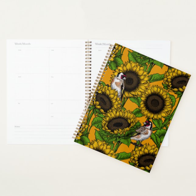 Sonnenblumen und Goldschmuck auf Orange Planer (Anzeige)