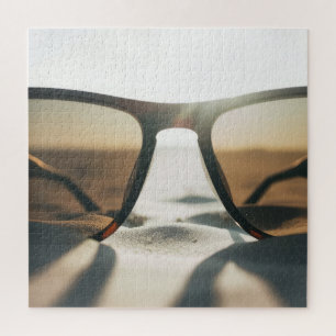 Sonnenbrille auf Sand Puzzle