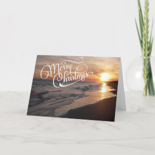 Sonnenstrand mit leuchtender Weihnachtskarte Feiertagskarte
