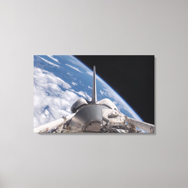 Space Shuttle Discovery im Hintergrund Leinwanddruck (Vorderseite)