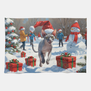 Sphynx-Katze läuft im Schnee mit Weihnachtsmütze Geschirrtuch