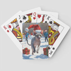 Sphynx-Katze läuft im Schnee mit Weihnachtsmütze Spielkarten