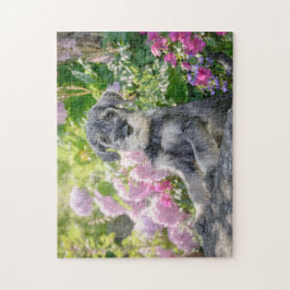 Standard Schnauzer Welpe in einem blühenden Garten Puzzle