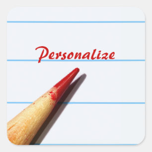 Stift des roten Lehrers auf gestrichenem Papier mi Quadratischer Aufkleber