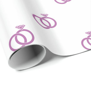 Strahlende Orchideen-Eheschließungsringe auf Weiß Geschenkpapier