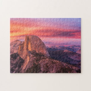 Sun, der über eine felsige Landschaft einstellt Puzzle