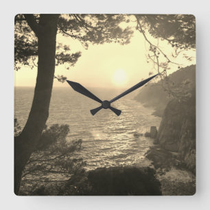 Sunset at the coast quadratische wanduhr