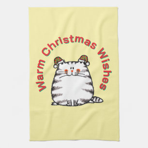 Süße dicke Katze mit zwei Weihnachtsmützen und war Geschirrtuch