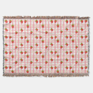 Süße Erdbeeren und Blumen auf rosa Gingham Decke