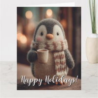 Süße gestrickte Pinguin-Puppe mit Schal und Tasse