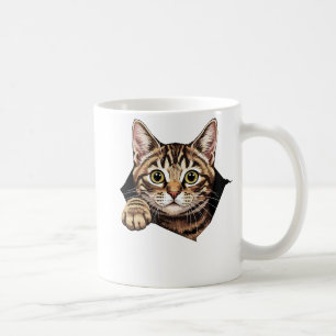 Süße Katze hat den Stoff zerrissen Katz reißt Kaffeetasse