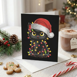 Süße schwarze Katze in Santa-Mütze mit Weihnachtsl Feiertagskarte
