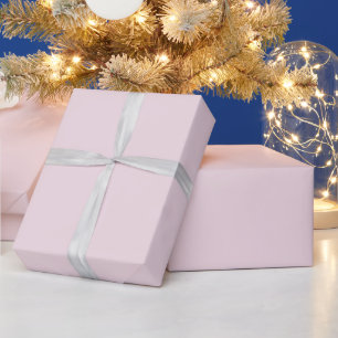 Süße Weihnachtsmeerjungfrau mit Santa-Hut auf Rosa Geschenkpapier