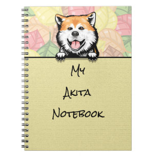 Süßer Akita schaut aus dem Notizbuch hervor Notizblock