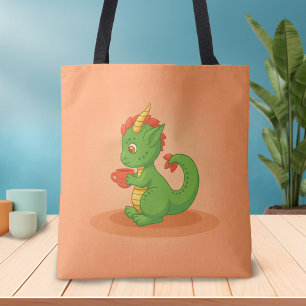 Süßer Baby-Drache hält Tasse auf Orange