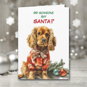 Süßer Cocker Spaniel Hund sucht nach Santa Feiertagskarte