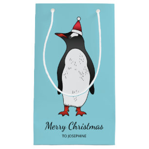 Süßer Gentoo-Pinguin mit Santa-Hut auf Blau Kleine Geschenktüte