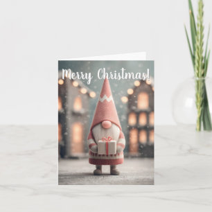 Süßer Weihnachts-Gnom mit einer Geschenkschachtel Feiertagskarte