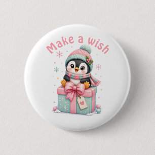 Süßer Weihnachts-Pinguin sitzt auf einer Geschenks Button