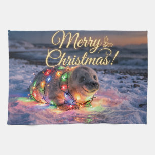 Süßes Babyrobbenbaby umwickelt mit Weihnachtslicht Geschirrtuch