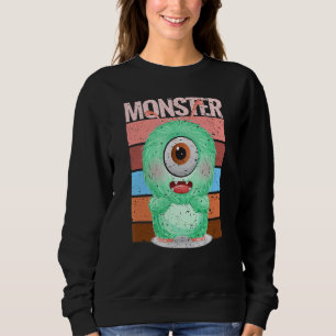 Süßes Monster in grüner Kruste mit einem riesigen  Sweatshirt