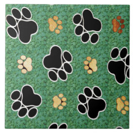 Tan und schwarze Pfote auf grünem Gras Fliese