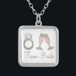 Team Bride Wedding Champagne Bridesmaid Necklace Versilberte Kette<br><div class="desc">Necklace ist eine originelle Marker-Illustration eines Glas blubbly Pink Champagner und eines Diamant Hochzeitsrings,  mit TEAM BRIDE in einem lustigen Schriftart. Eine großartige Brautjungfrau / Brautparty Geschenk!</div>