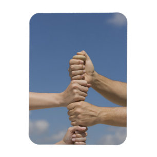 Team-Hände auf Schläger Magnet