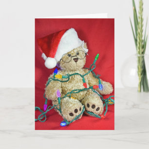 Teddy Bär in den Weihnachtslichtern Feiertagskarte
