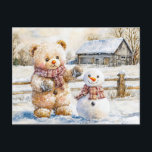 Teddy Bear Building a Snowman Postkarte<br><div class="desc">Charming watercolor illustration of a teddy bear creating a snowman in a winter wonderland, capturing the joy of a snowy day. Ideal for seasonal greetings and childrens stories.</div>